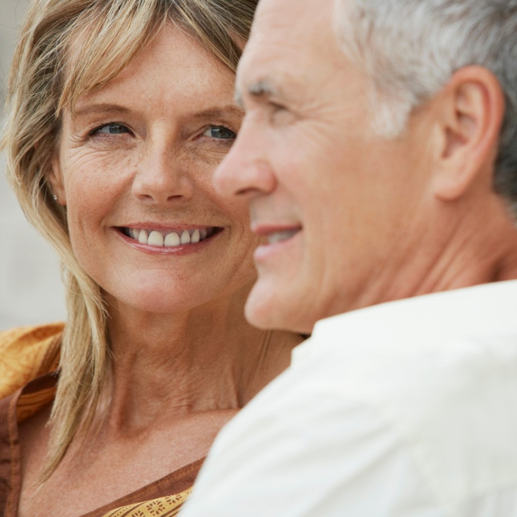 A dental professional fitting dentures for a patient at a dental practice.